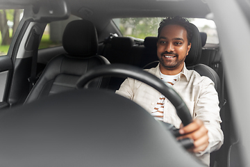 Image showing smiling indian man or driver driving car
