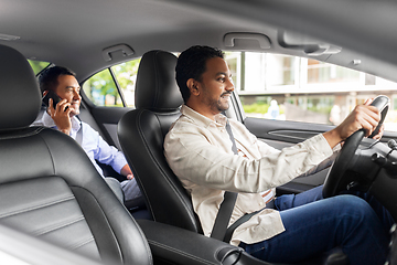 Image showing male passenger calling on smartphone in taxi car