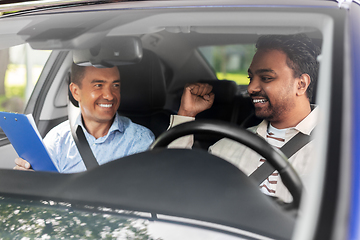 Image showing smiling car driving school instructor and driver