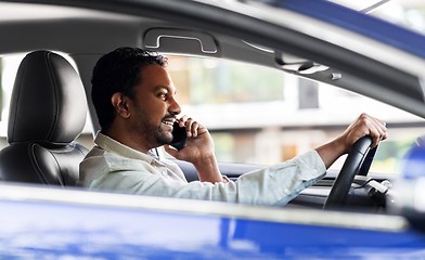 Image showing indian man driving car and calling on smartphone