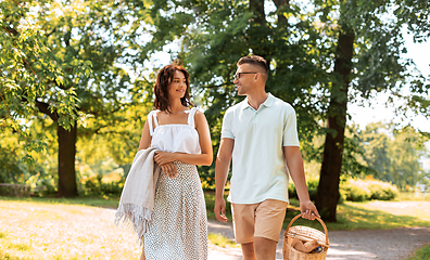 Image showing happy couple with picnic basket at summer park