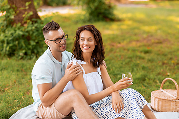 Image showing happy couple having picnic at summer park