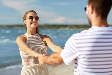 Image showing happy couple hugging on summer beach