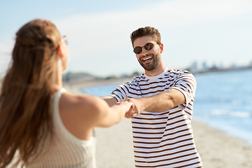 Image showing happy couple hugging on summer beach