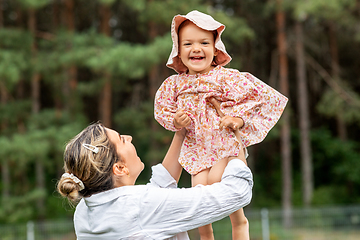 Image showing happy smiling mother with baby girl outdoors