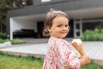 Image showing happy little baby girl eating ice cream