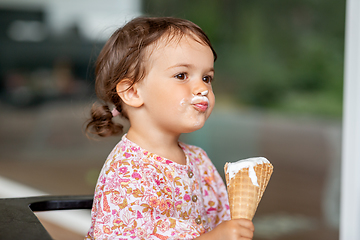 Image showing happy little baby girl eating ice cream