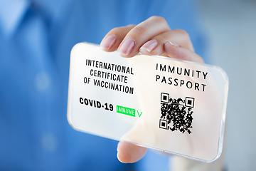 Image showing hand with virtual immunity passport on smartphone