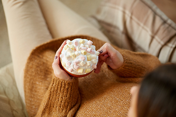 Image showing woman holding mug of marshmallow and whipped cream