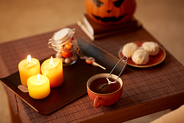 Image showing mesh tea infuser ball in ceramic mug on halloween