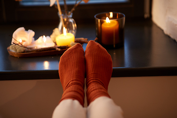 Image showing feet in socks on window sill at home in autumn