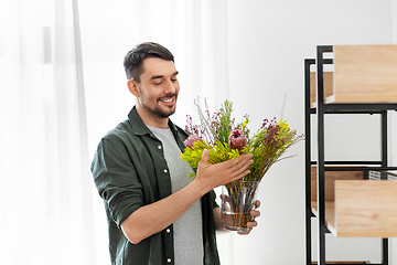 Image showing man decorating home with flower or houseplant