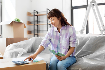 Image showing asian woman moving to new home and counting money