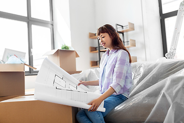 Image showing woman with blueprint and boxes moving to new home