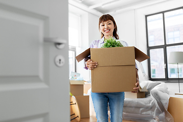 Image showing happy woman unpacking boxes and moving to new home