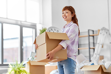 Image showing happy woman unpacking boxes and moving to new home