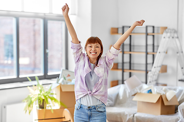 Image showing happy asian woman with stuff moving to new home