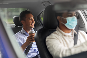 Image showing male passenger with coffee and car driver in mask