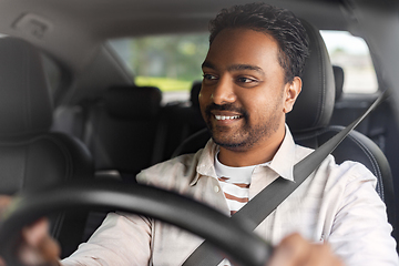 Image showing smiling indian man or driver driving car