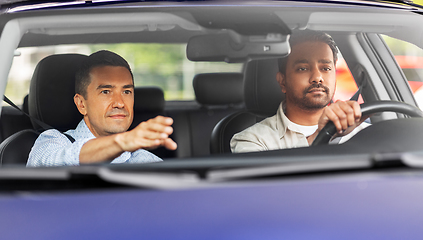 Image showing car driving school instructor teaching male driver