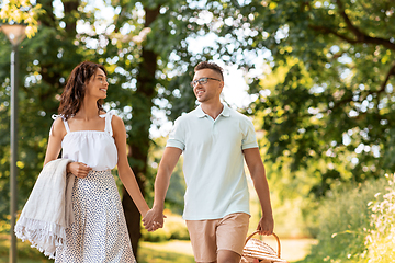 Image showing happy couple with picnic basket at summer park
