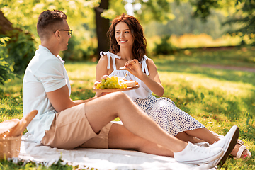 Image showing happy couple having picnic at summer park