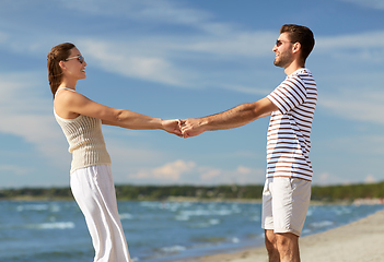 Image showing happy couple hugging on summer beach