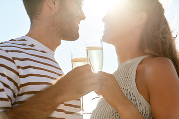 Image showing happy couple drinking champagne on summer beach