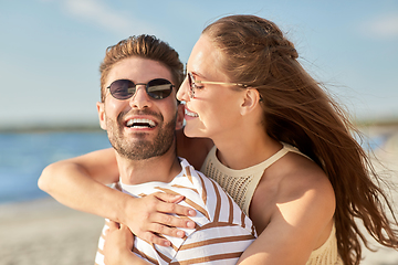 Image showing happy couple hugging on summer beach