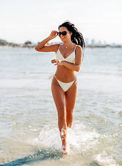 Image showing smiling young woman in bikini swimsuit on beach