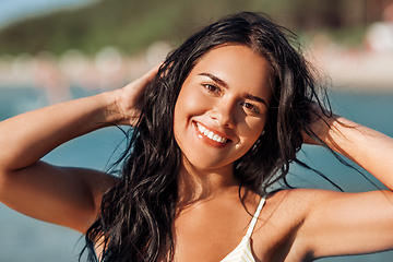 Image showing smiling young woman in bikini swimsuit on beach