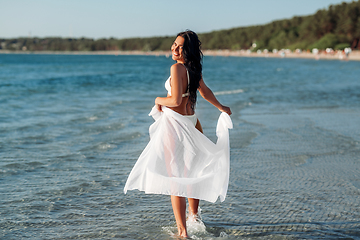 Image showing woman in bikini swimsuit with cover-up on beach