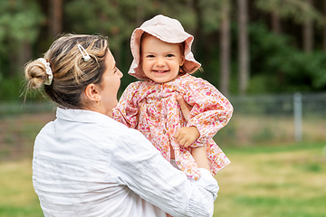 Image showing happy smiling mother with baby girl outdoors