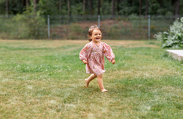 Image showing happy little baby girl running barefoot on grass