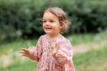 Image showing happy little baby girl outdoors in summer