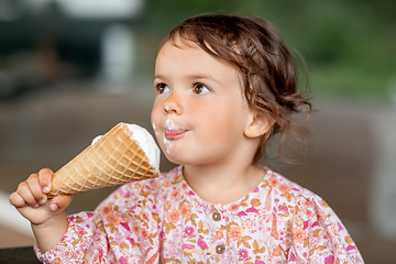 Image showing happy little baby girl eating ice cream