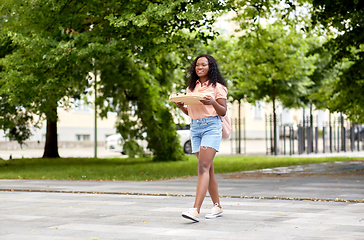 Image showing african student girl with takeaway pizza in city