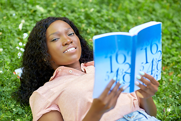 Image showing african student girl reading math textbook