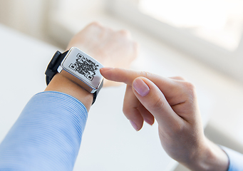 Image showing woman's hands with qr code on smart watch