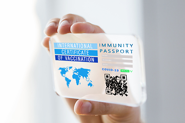 Image showing hand holding phone with certificate of vaccination