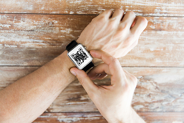 Image showing male hands with qr code on smart watch