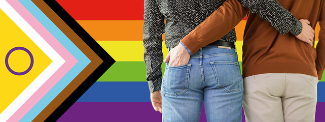 Image showing close up of male gay couple over pride flag