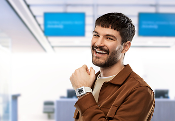 Image showing man showing smart watch with qr code on screen