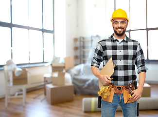 Image showing male builder in helmet with clipboard at home