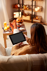 Image showing woman with tablet pc at home on halloween