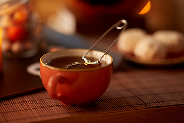 Image showing mesh tea infuser ball in ceramic mug on halloween