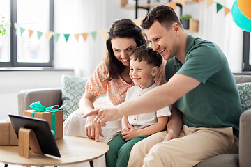 Image showing happy family with tablet pc at home on birthday