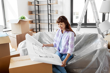 Image showing woman with blueprint and boxes moving to new home