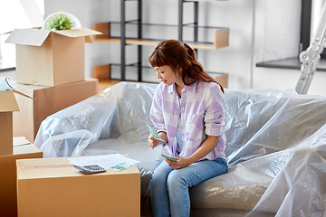 Image showing asian woman moving to new home and counting money