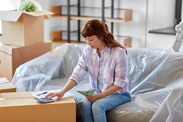 Image showing asian woman moving to new home and counting money